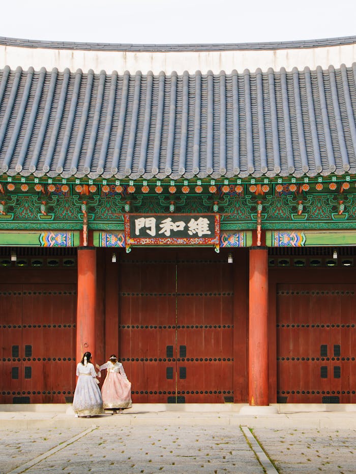Visitors in hanbok at a historic Korean palace in Seoul, South Korea.